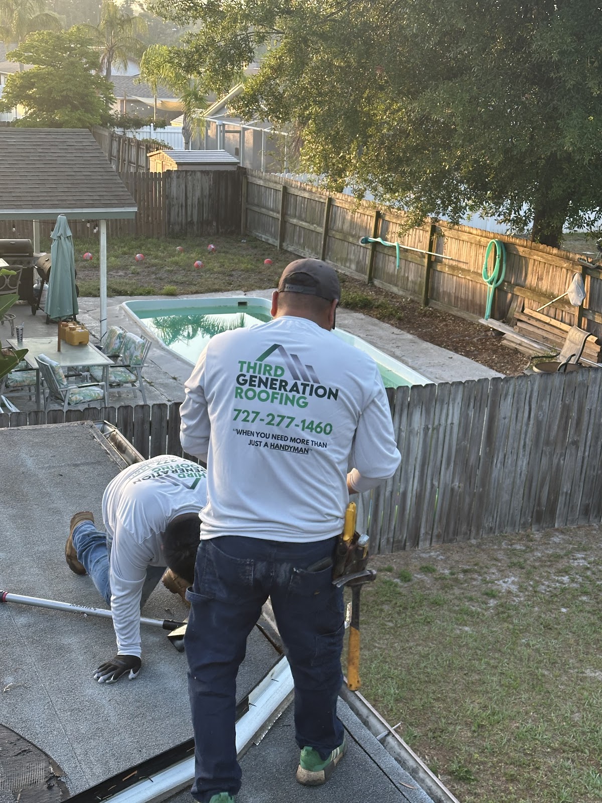 Crew member wearing a Third Generation Roofing shirt at a job site