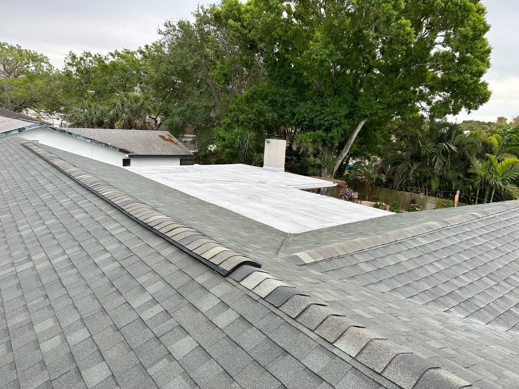 Completed shingle roof with a flat-roof section
