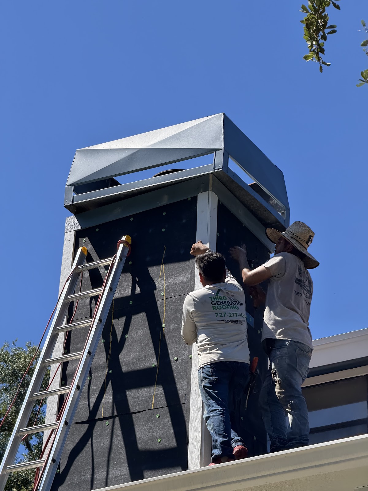 Roofers working on a house exterior